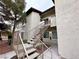 Exterior staircase leading up to a second-floor unit, surrounded by mature trees at 3354 Indian Shadow St # 203, Las Vegas, NV 89129