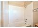 White tiled bath tub and shower combination with updated faucet hardware at 3434 Toquima Cir, Las Vegas, NV 89120