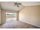 Bright bedroom featuring neutral carpet, ceiling fan, and sliding glass door to the backyard at 3434 Toquima Cir, Las Vegas, NV 89120