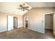 Bedroom with a ceiling fan, carpet, and two doorways with tile flooring visible in the background at 3434 Toquima Cir, Las Vegas, NV 89120