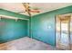 Bedroom with green walls, ceiling fan, and closet space at 3434 Toquima Cir, Las Vegas, NV 89120