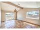 Spacious living area with beamed ceiling, tile floors, and sliding glass doors to the backyard at 3434 Toquima Cir, Las Vegas, NV 89120