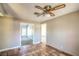 Neutral living room with tile flooring, ceiling fan, and multiple doorways to other rooms at 3434 Toquima Cir, Las Vegas, NV 89120