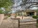 Charming backyard featuring a stone fire pit, a statue, manicured landscaping, and a privacy fence at 3476 Ridge Meadow St, Las Vegas, NV 89135