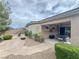Spacious backyard featuring a covered patio, lush landscaping, rock features, and a cozy seating area at 3476 Ridge Meadow St, Las Vegas, NV 89135