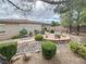 Serene backyard with a stone fire pit, lush landscaping, rock features, and inviting seating at 3476 Ridge Meadow St, Las Vegas, NV 89135