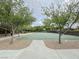 Outdoor basketball court surrounded by trees, featuring a smooth playing surface and well-maintained grounds at 3476 Ridge Meadow St, Las Vegas, NV 89135
