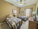 Inviting bedroom featuring twin beds, a ceiling fan, and neutral decor at 3476 Ridge Meadow St, Las Vegas, NV 89135