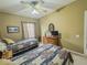 Cozy bedroom featuring two beds, ceiling fan, and dresser, creating a comfortable and inviting space at 3476 Ridge Meadow St, Las Vegas, NV 89135