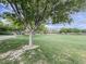 Expansive community green space with mature trees, a lawn area, and recreational facilities for residents at 3476 Ridge Meadow St, Las Vegas, NV 89135