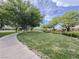 Well-maintained community lawn featuring a sidewalk and mature trees, offering a picturesque view of the neighborhood at 3476 Ridge Meadow St, Las Vegas, NV 89135