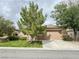 Home exterior with a two car garage, landscaped yard, and stone accents providing beautiful curb appeal at 3476 Ridge Meadow St, Las Vegas, NV 89135