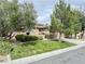 Charming home exterior with a lush lawn, mature trees, and a welcoming entrance in a lovely neighborhood at 3476 Ridge Meadow St, Las Vegas, NV 89135