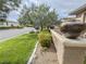 Landscaped front yard featuring decorative planters, lush greenery, and a stone-accented retaining wall at 3476 Ridge Meadow St, Las Vegas, NV 89135