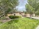 Manicured front yard with mature trees and shrubs, showcasing the home's curb appeal at 3476 Ridge Meadow St, Las Vegas, NV 89135