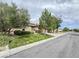 Charming single-story home with manicured lawn, mature trees, and stone accents on the façade at 3476 Ridge Meadow St, Las Vegas, NV 89135
