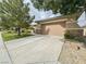 Attached two-car garage with concrete driveway and well-maintained landscaping at 3476 Ridge Meadow St, Las Vegas, NV 89135