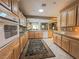 Open-concept kitchen featuring oak cabinetry, modern appliances, and seamless flow into the living area at 3476 Ridge Meadow St, Las Vegas, NV 89135