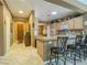 Bright kitchen featuring a breakfast bar and tile flooring throughout at 3476 Ridge Meadow St, Las Vegas, NV 89135