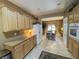 Bright kitchen featuring oak cabinets, granite countertops, and an open layout into the dining area at 3476 Ridge Meadow St, Las Vegas, NV 89135