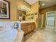 Well lit primary bathroom featuring dual sinks, tiled floors, and a glass shower at 3476 Ridge Meadow St, Las Vegas, NV 89135