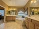 The primary bathroom features dual sinks, a soaking tub, and tile floors at 3476 Ridge Meadow St, Las Vegas, NV 89135