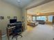 From a built in desk area, an expansive main bedroom with a cozy seating area is displayed at 3476 Ridge Meadow St, Las Vegas, NV 89135