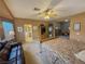 Spacious main bedroom with a ceiling fan, a sitting area, and an attached bathroom at 3476 Ridge Meadow St, Las Vegas, NV 89135