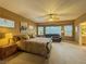 Spacious main bedroom with abundant natural light, ceiling fan and comfortable seating area at 3476 Ridge Meadow St, Las Vegas, NV 89135