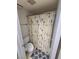 Bathroom with a shower behind a floral curtain, alongside a toilet and patterned floor mat at 3660 Haverhill St, Las Vegas, NV 89121