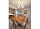 Inviting dining area with a wood table, six chairs, chandelier, and cabinetry at 3660 Haverhill St, Las Vegas, NV 89121