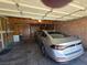 The well-lit garage accommodates a silver car with storage and workspace, all under a paneled ceiling at 3660 Haverhill St, Las Vegas, NV 89121