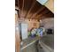 Cluttered garage featuring a silver car, storage cabinets, wooden beams and block wall at 3660 Haverhill St, Las Vegas, NV 89121