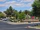 Neighborhood entrance with colorful landscaping, a stop sign, and park benches for community enjoyment at 3660 Haverhill St, Las Vegas, NV 89121