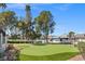 Putting green perfect for golf enthusiasts, enhanced by mature trees and well-maintained grounds at 3660 Haverhill St, Las Vegas, NV 89121