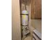 Water heater installation with organized piping, safety label, and shoe rack at 3660 Haverhill St, Las Vegas, NV 89121