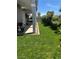 Landscaped backyard with grass lawn, grill, and outdoor seating under covered patio at 3805 White Castle St, Las Vegas, NV 89129