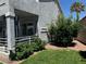Landscaped backyard with shrubs, decorative rock, and inviting covered patio area at 3805 White Castle St, Las Vegas, NV 89129