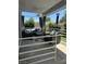 Cozy outdoor living space with comfortable seating, ceiling fan, string lights, and a view to backyard at 3805 White Castle St, Las Vegas, NV 89129