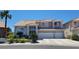 Charming two-story home featuring a three-car garage, tile roof, and landscaped front yard at 3805 White Castle St, Las Vegas, NV 89129