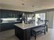 Modern kitchen with dark cabinets, a large center island, and stainless steel appliances at 3805 White Castle St, Las Vegas, NV 89129