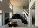 Spacious living room with high ceilings, gas fireplace, entertainment center, and staircase at 3805 White Castle St, Las Vegas, NV 89129