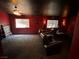 This living room has a black ceiling, red walls and comfortable seating at 3805 White Castle St, Las Vegas, NV 89129