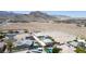 Expansive aerial view of desert property with custom homes, mountain views, and vast potential at 4070 N Tee Pee Ln, Las Vegas, NV 89129