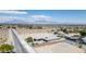 Picturesque aerial perspective of a desert landscape featuring houses with swimming pools, mountains in the horizon at 4070 N Tee Pee Ln, Las Vegas, NV 89129