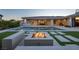 Inviting backyard with pool, fire pit, artificial turf and covered patio, perfect for outdoor entertaining at 4070 N Tee Pee Ln, Las Vegas, NV 89129