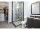 Well-lit bathroom featuring a glass-enclosed shower, modern fixtures, and access to a walk-in closet at 4070 N Tee Pee Ln, Las Vegas, NV 89129