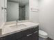 Modern bathroom features a vanity with sleek fixtures and a large mirror at 4070 N Tee Pee Ln, Las Vegas, NV 89129