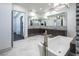 Elegant bathroom with marble floors, a large mirror, and a modern tub at 4070 N Tee Pee Ln, Las Vegas, NV 89129