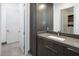 Modern bathroom featuring a sleek vanity and a doorway that opens to a walk-in closet at 4070 N Tee Pee Ln, Las Vegas, NV 89129